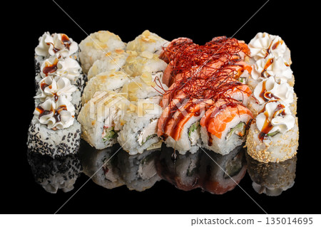 Assorted sushi rolls set with salmon, cream cheese and sauces isolated on black background 135014695