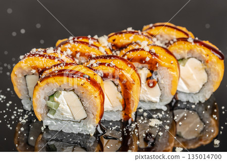 Baked sushi roll with mango cream cheese and eel sauce close up Baked sushi roll with mango cream cheese and eel sauce close up 135014700