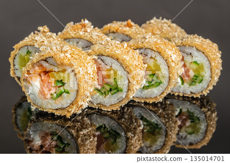 Baked sushi roll with salmon cucumber and crunchy coating close up 135014701