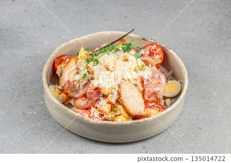 Chicken caesar salad with parmesan cheese, bacon and croutons served in ceramic bowl with copy space Chicken caesar salad with parmesan cheese, bacon and croutons served in ceramic bowl with copy space 135014722