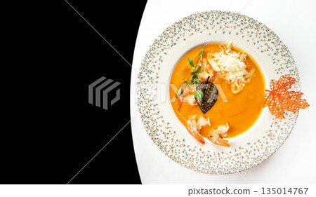 Gourmet pumpkin cream soup with shrimp and cheese on elegant plate, top view, copy space Gourmet pumpkin cream soup with shrimp and cheese on elegant plate, top view, copy space 135014767