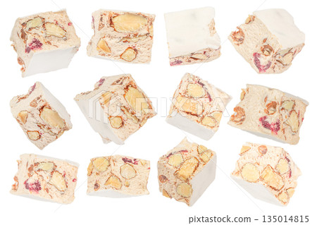 Traditional Italian Christmas dessert torrone nougat pieces with nuts and honey isolated on white background Traditional Italian Christmas dessert torrone nougat pieces with nuts and honey isolated on white background 135014815