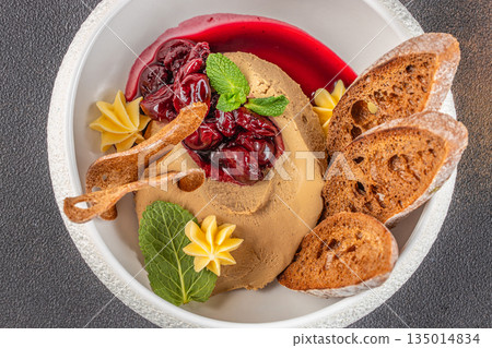 Gourmet chicken liver pate with cherry sauce, toast, and butter cream garnish Gourmet chicken liver pate with cherry sauce, toast, and butter cream garnish 135014834