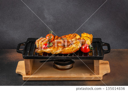 Grilled chicken with corn and tomatoes on cast iron grill Grilled chicken with corn and tomatoes on cast iron grill 135014836
