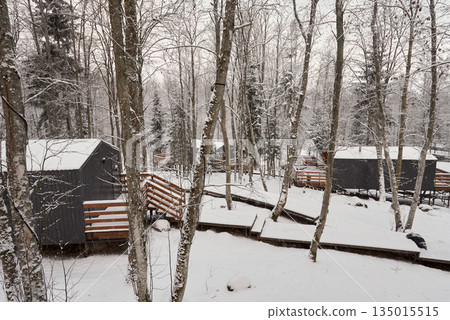 Peaceful winter setting with rustic homes and snowcovered walkways Peaceful winter setting with rustic homes and snowcovered walkways 135015515