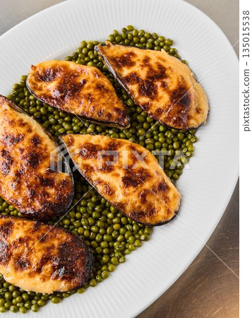 Elegant serving of roasted mussels on peas with lemon wedge Elegant serving of roasted mussels on peas with lemon wedge 135015538