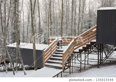 Remote offgrid wooden structure in snowy forest environment Remote offgrid wooden structure in snowy forest environment 135015544
