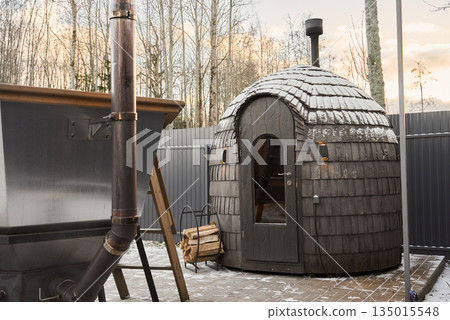 Scene depicts sauna ready for relaxation with glowing heat source Scene depicts sauna ready for relaxation with glowing heat source 135015548