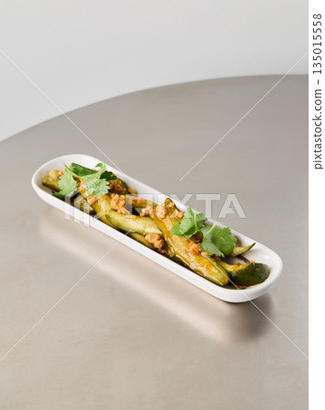 Gourmet asparagus confit enhanced by lemon herb oil and toasted seeds 135015558