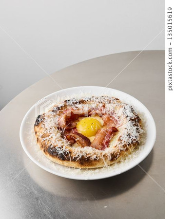 Gourmet ham and egg pastry displayed on minimalist dish Gourmet ham and egg pastry displayed on minimalist dish 135015619