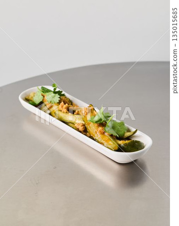 Cilantroseasoned finger potatoes displayed on sleek ceramic dish 135015685