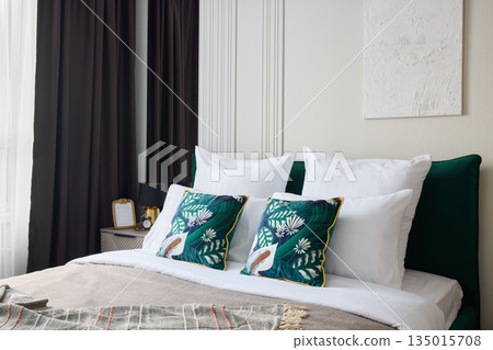 Botanical accent bedroom with emerald pillows and floral cushions 135015708