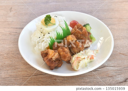 crispy fried garlic chicken with boiled egg on black sesame rice and salad bento set in plate crispy fried garlic chicken with boiled egg on black sesame rice and salad bento set in plate 135015939