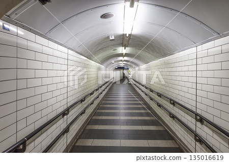 Empty White Tiled Underground Pedestrian Tunnel Empty White Tiled Underground Pedestrian Tunnel 135016619