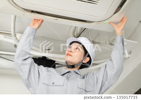 Workers inspecting air conditioners Workers inspecting air conditioners 135017735