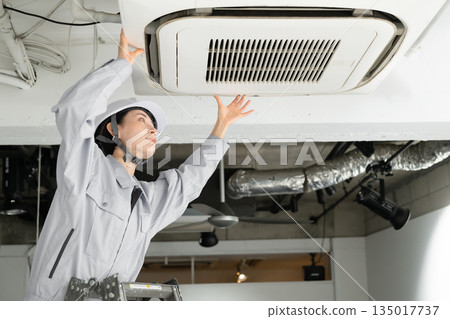 Workers inspecting air conditioners Workers inspecting air conditioners 135017737