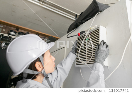 Workers inspecting air conditioners 135017741