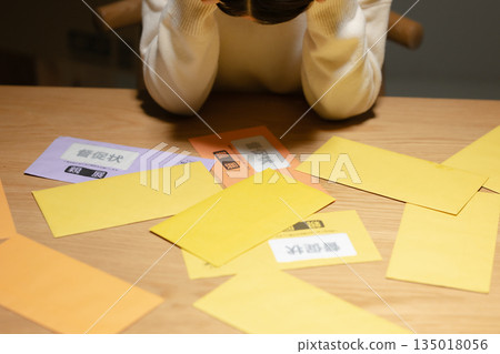A woman troubled by a demand letter A woman troubled by a demand letter 135018056