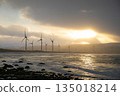 Windmill silhouette illuminated by the setting sun 135018214