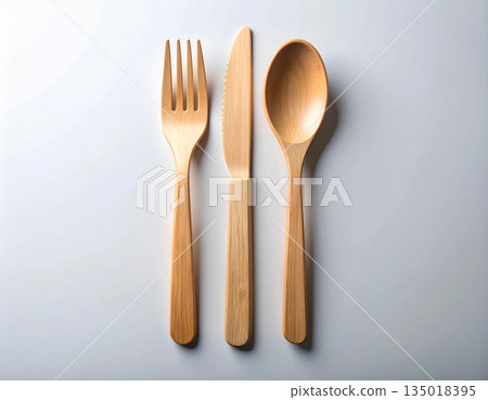 Sustainable packaging. Set of eco-friendly bamboo cutlery: wooden spoon, fork and knife on a white background. 135018395