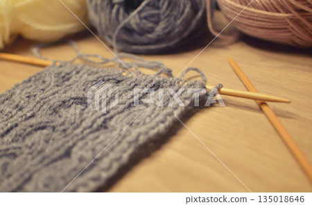 Photo of cable knitting in progress with knitting needles. Knitting, Yarn, Aran pattern, Hobby Photo of cable knitting in progress with knitting needles. Knitting, Yarn, Aran pattern, Hobby 135018646