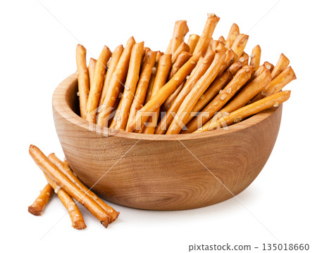 Pretzel sticks in a wooden plate on a white background. Isolated Pretzel sticks in a wooden plate on a white background. Isolated 135018660