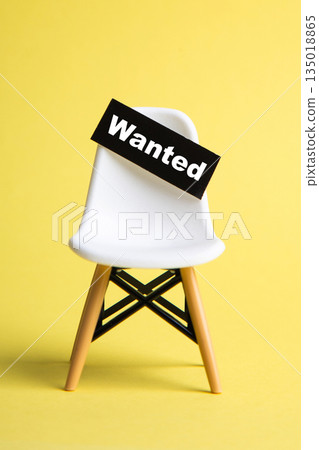 White chair with wanted sign representing job vacancy 135018865