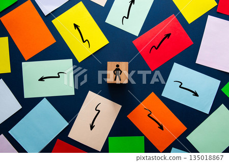 Person icon choosing direction among multiple arrow options 135018867