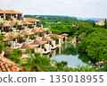 A luxury resort hotel and courtyard with vibrant palm trees against the refreshing blue tropical sky (Miyakojima City, Okinawa Prefecture) 135018955