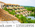 A luxury resort hotel and courtyard with vibrant palm trees against the refreshing blue tropical sky (Miyakojima City, Okinawa Prefecture) 135018956