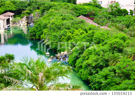 The lagoon, courtyard, pond and waterfall of a luxury resort hotel, where vibrant tropical palm trees stand out (Miyakojima City, Okinawa Prefecture) The lagoon, courtyard, pond and waterfall of a luxury resort hotel, where vibrant tropical palm trees stand out (Miyakojima City, Okinawa Prefecture) 135019213