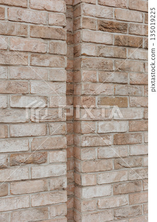 Textured brick wall corner with natural tones 135019225