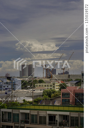 View of Construction of tall buildings with a crane and background of Dramatic sky in the city of Bangkok. 135019572