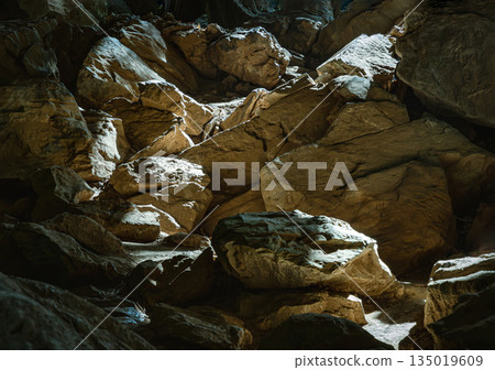 The sunlight shining through Stalagmites inside Cave of Hup Pa Tat. The sunlight shining through Stalagmites inside Cave of Hup Pa Tat. 135019609