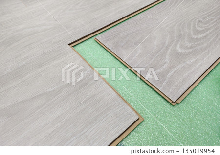Installing laminated floor, wooden tile, over gteen foam base layer 135019954