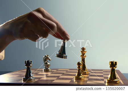 Key chess decision moment with queen hovering above square. 135020007