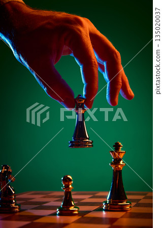 Strategic chess move with black queen lifted above board. 135020037