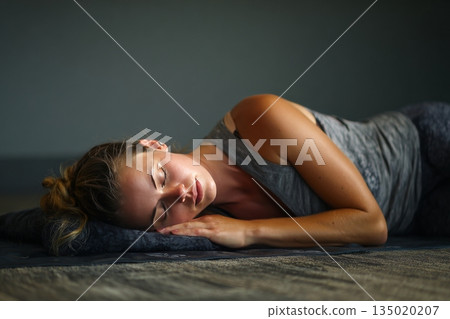 Group of young sporty people practicing yoga lesson with instructor in gym, , doing Savasana, generated AI 135020207