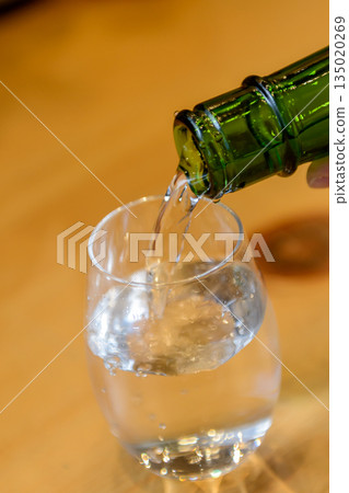 Sake being poured into a glass Sake being poured into a glass 135020269