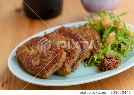 Daikon mochi and garnish vegetables on a plate Daikon mochi and garnish vegetables on a plate 135020441