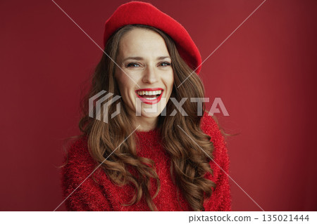 smiling woman in sweater and beret isolated on background smiling woman in sweater and beret isolated on background 135021444