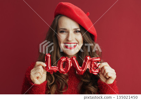happy modern woman in red sweater and beret 135021450