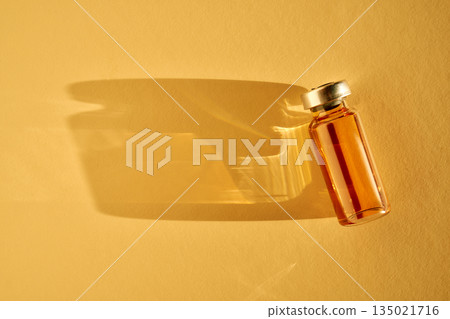 Vial containing orange liquid medicine representing health protection 135021716