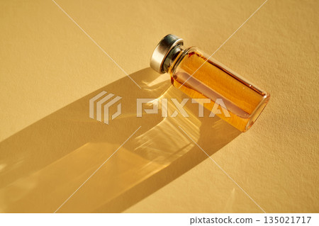 Vial containing liquid medicine casting bright shadow 135021717