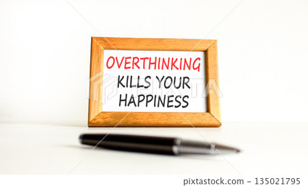 Overthinking kills your happiness symbol. Concept words Overthinking kills your happiness on wooden picture frame. Beautiful white background. Business overthinking kills happiness concept. Copy space 135021795