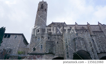 The image shows the remains of the Roman Walls of Barcelona Muralla romana de Barcelona and adjacent buildings in the city Gothic Quarter. The image shows the remains of the Roman Walls of Barcelona Muralla romana de Barcelona and adjacent buildings in the city Gothic Quarter. 135022060