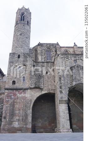 The image shows the remains of the Roman Walls of Barcelona Muralla romana de Barcelona and adjacent buildings in the city Gothic Quarter. The image shows the remains of the Roman Walls of Barcelona Muralla romana de Barcelona and adjacent buildings in the city Gothic Quarter. 135022061