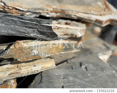 Rough slate stones stacked as a textured natural background 135022218