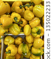 Yellow bell peppers piled in crates at market, vibrant fresh produce, suitable as background 135022233
