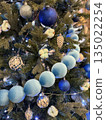 Christmas tree decorated with blue ornaments and lights, festive holiday background 135022254